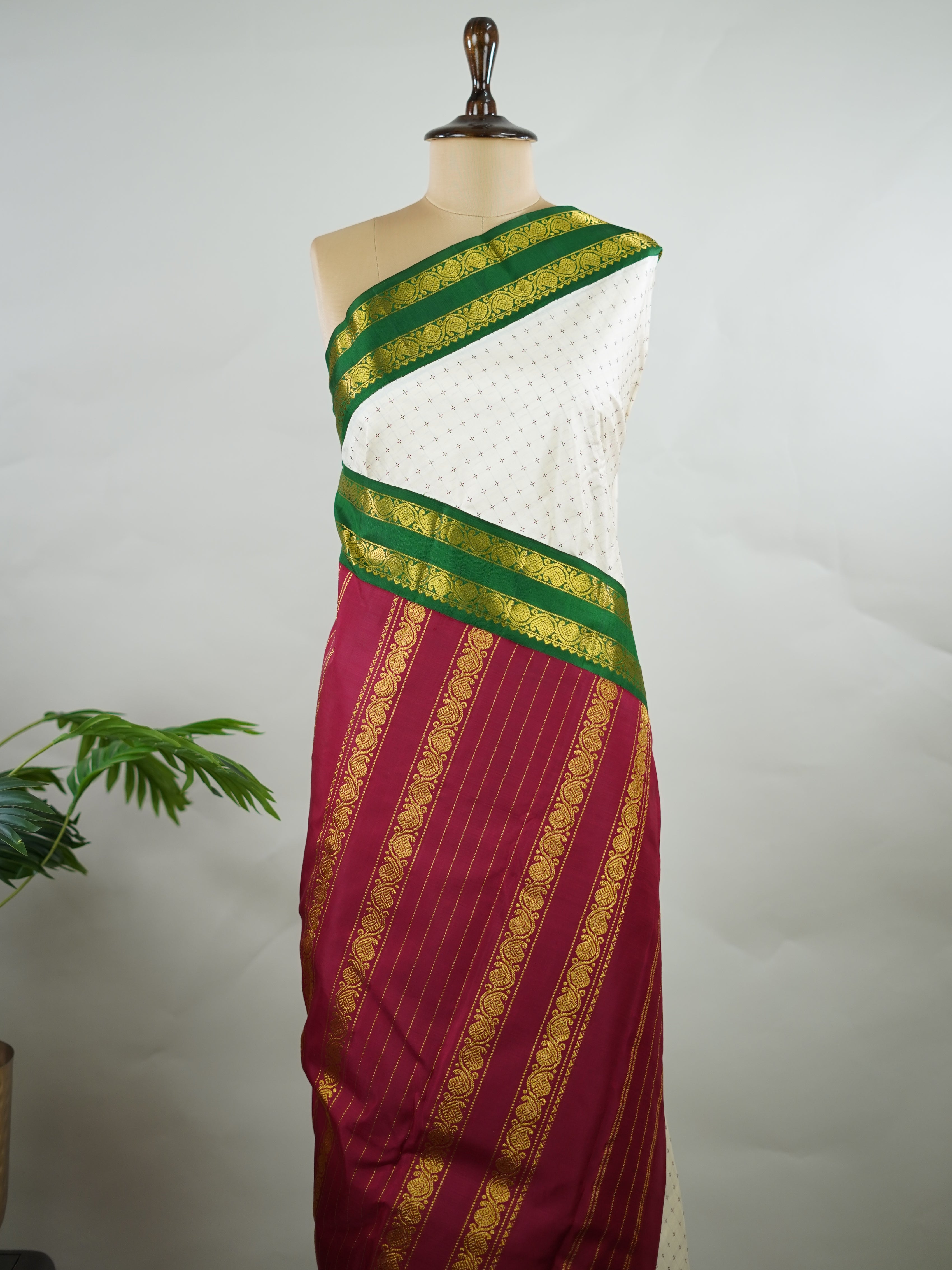 Kanchipuram Silk Pure silk with white Laksha Deepam style buttas on the body.
Paired with dual pallu in green and maroon, and a maroon blouse.
Accented with a classic Ganga-Jamuna border for timeless elegance. Sivamayi - Manoranjitham Weaves - Handloom Store