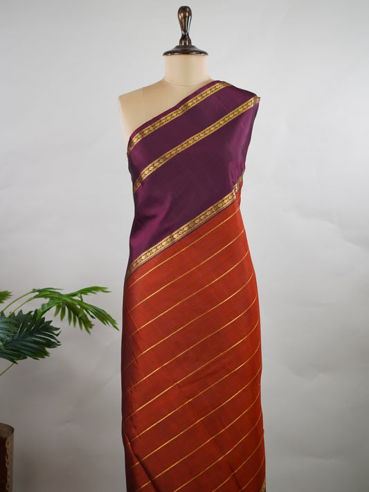 Kanchipuram Silk Pure silk in rust orange with bold horizontal stripes.
Paired with big purple gap borders.
A striking combination of colour and traditional craftsmanship. Kamini - Manoranjitham Weaves - Handloom Store