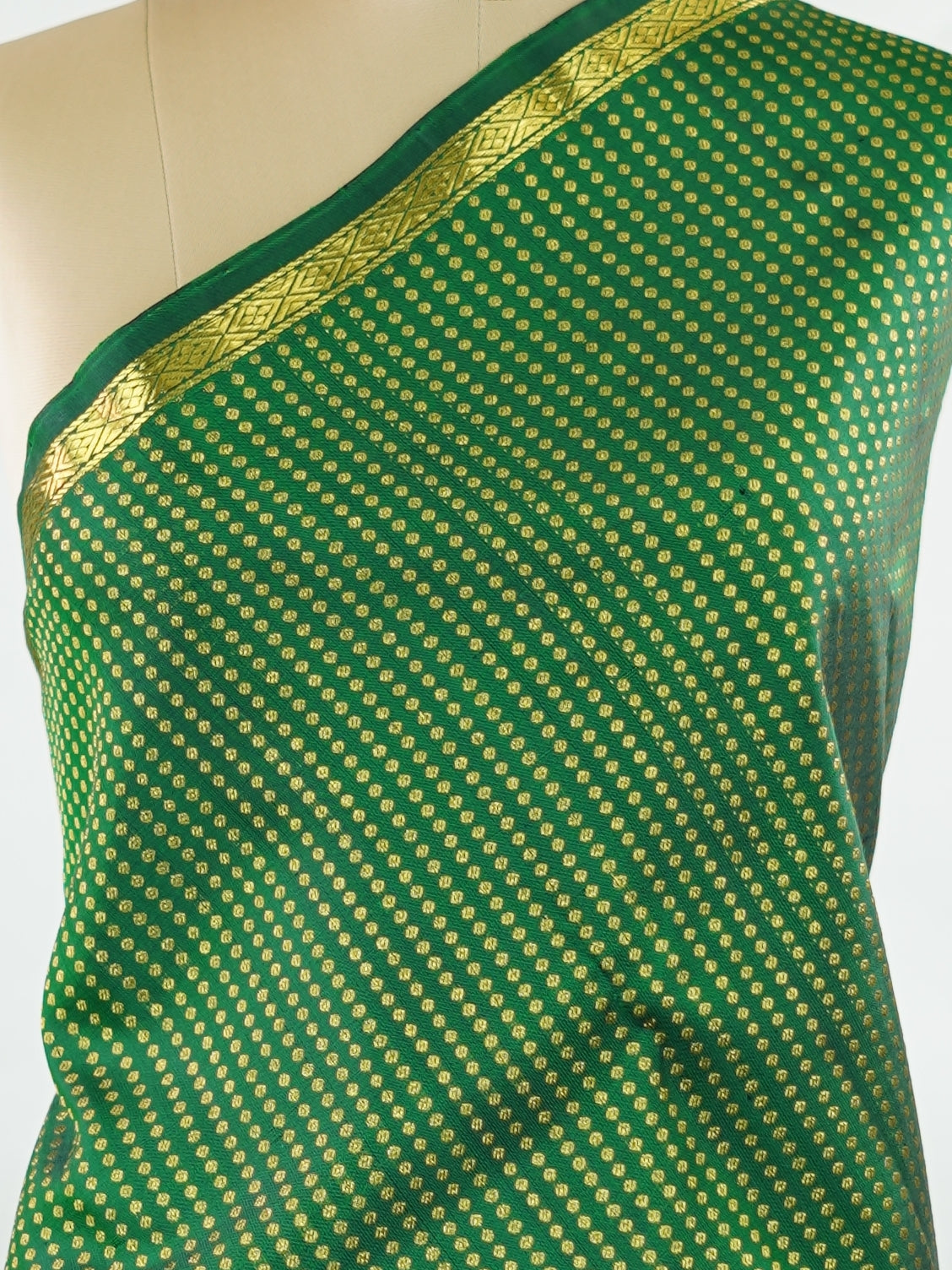 Kanchipuram Silk Crafted in luxurious 100% pure silk, this elegant green Kanjivaram saree is a timeless classic. The body is adorned with delicate small buttis that add subtle charm and richness to the weave. Perfect for weddings, festive occasions, and special celebrations, it drapes beautifully with a regal yet graceful appeal. Shivapriya - Green Pure Kanjivaram Silk Saree - Manoranjitham Weaves - Handloom Store