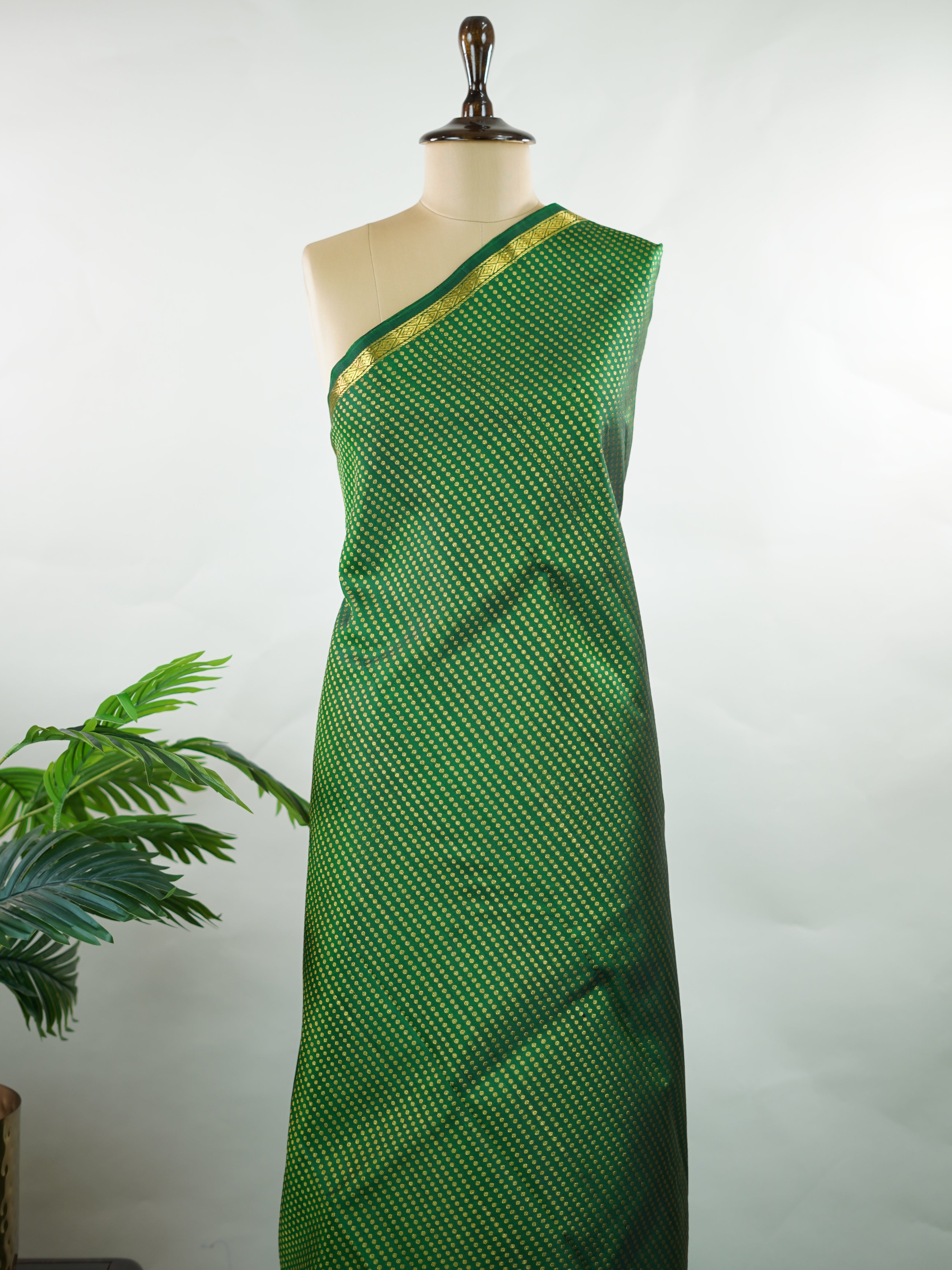 Kanchipuram Silk Crafted in luxurious 100% pure silk, this elegant green Kanjivaram saree is a timeless classic. The body is adorned with delicate small buttis that add subtle charm and richness to the weave. Perfect for weddings, festive occasions, and special celebrations, it drapes beautifully with a regal yet graceful appeal. Shivapriya - Green Pure Kanjivaram Silk Saree - Manoranjitham Weaves - Handloom Store