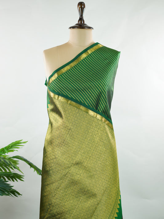 Kanchipuram Silk Crafted in luxurious 100% pure silk, this elegant green Kanjivaram saree is a timeless classic. The body is adorned with delicate small buttis that add subtle charm and richness to the weave. Perfect for weddings, festive occasions, and special celebrations, it drapes beautifully with a regal yet graceful appeal. Shivapriya - Manoranjitham Weaves - Handloom Store