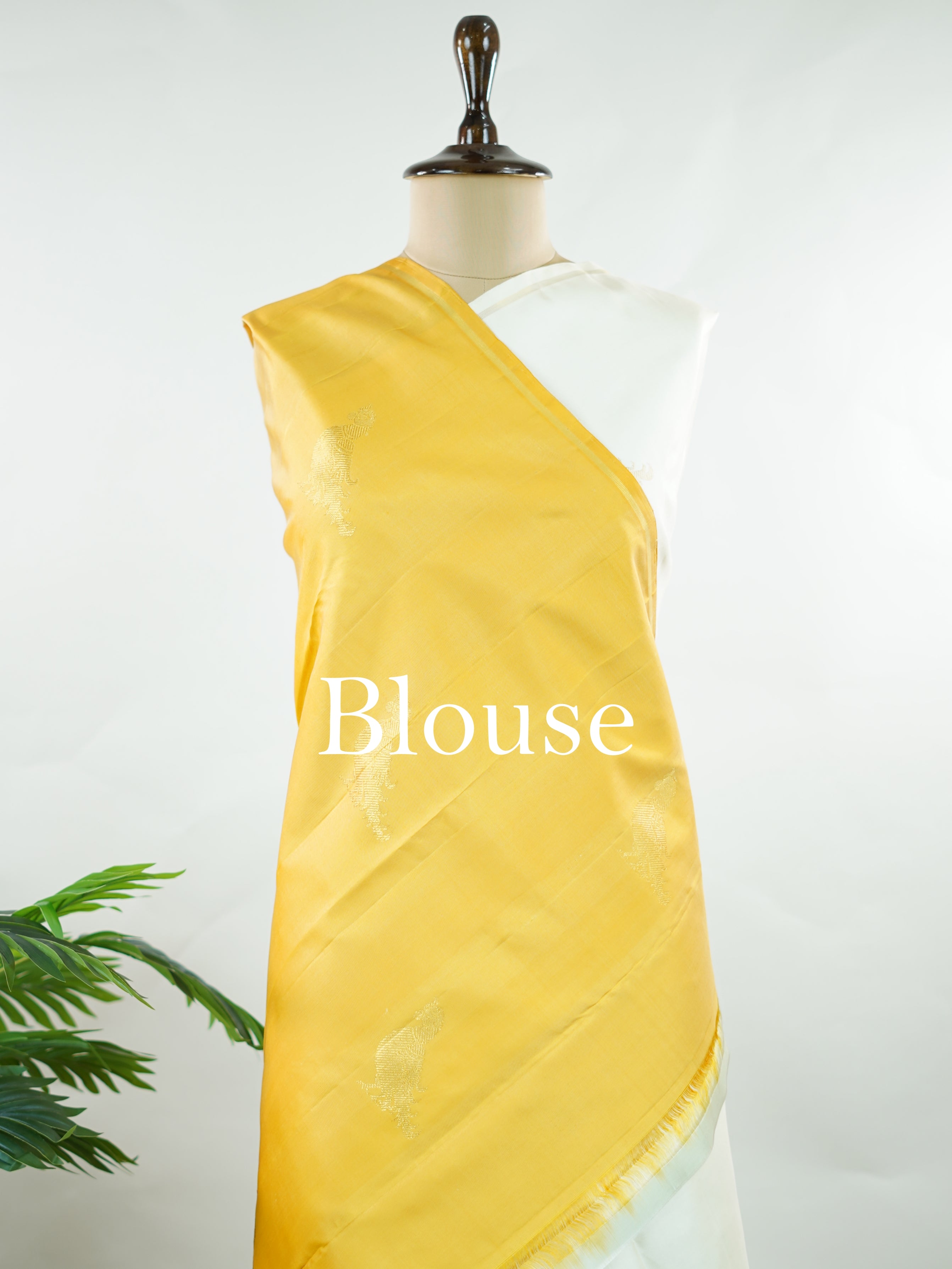 Kanchipuram Silk Elegant and refreshing, this white and yellow Kanjivaram saree is woven in luxurious 100% pure silk for a rich, graceful drape. The body features charming parrot motifs that stand out beautifully against the soft contrast tones. Designed without a traditional border, it offers a modern, seamless look while retaining the timeless grandeur of classic Kanjivaram craftsmanship. Tripurasundari - Yellow Pure Kanjivaram Silk Saree - Manoranjitham Weaves - Handloom Store