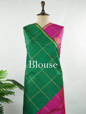 Kanchipuram Silk A beautiful celebration of tradition, this pink and green Kanjivaram saree is woven in rich 100% pure silk for a regal drape. The body features intricate Kolam buttis paired with classic checks, creating a harmonious blend of heritage artistry and structured design. Vibrant yet timeless, it’s a perfect choice for weddings, festive gatherings, and special occasions. Shambhavi - Green Pure Kanjivaram Silk Saree - Manoranjitham Weaves - Handloom Store