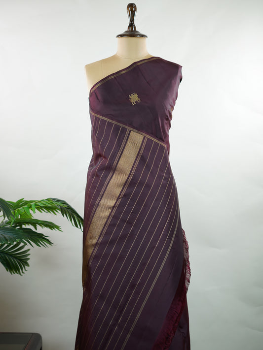 Kanchipuram Silk Rich and earthy, this snuff-toned Kanjivaram saree is crafted in luxurious 100% pure silk for a graceful, structured drape. The body is adorned with elegant buttas that add depth and traditional charm to the weave. Subtle yet regal, it’s a timeless choice for weddings, festive occasions, and classic celebrations. Adishakti - Manoranjitham Weaves - Handloom Store