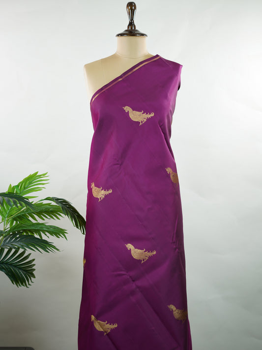 Kanchipuram Silk Vibrant and eye-catching, this magenta pink and mustard Kanjivaram saree is woven in luxurious 100% pure silk for a rich, graceful drape. The body is beautifully adorned with charming parrot buttis, adding a playful yet traditional touch to the design. Bold in contrast and timeless in appeal, it’s perfect for weddings, festive celebrations, and grand occasions Chandrakala - Manoranjitham Weaves - Handloom Store