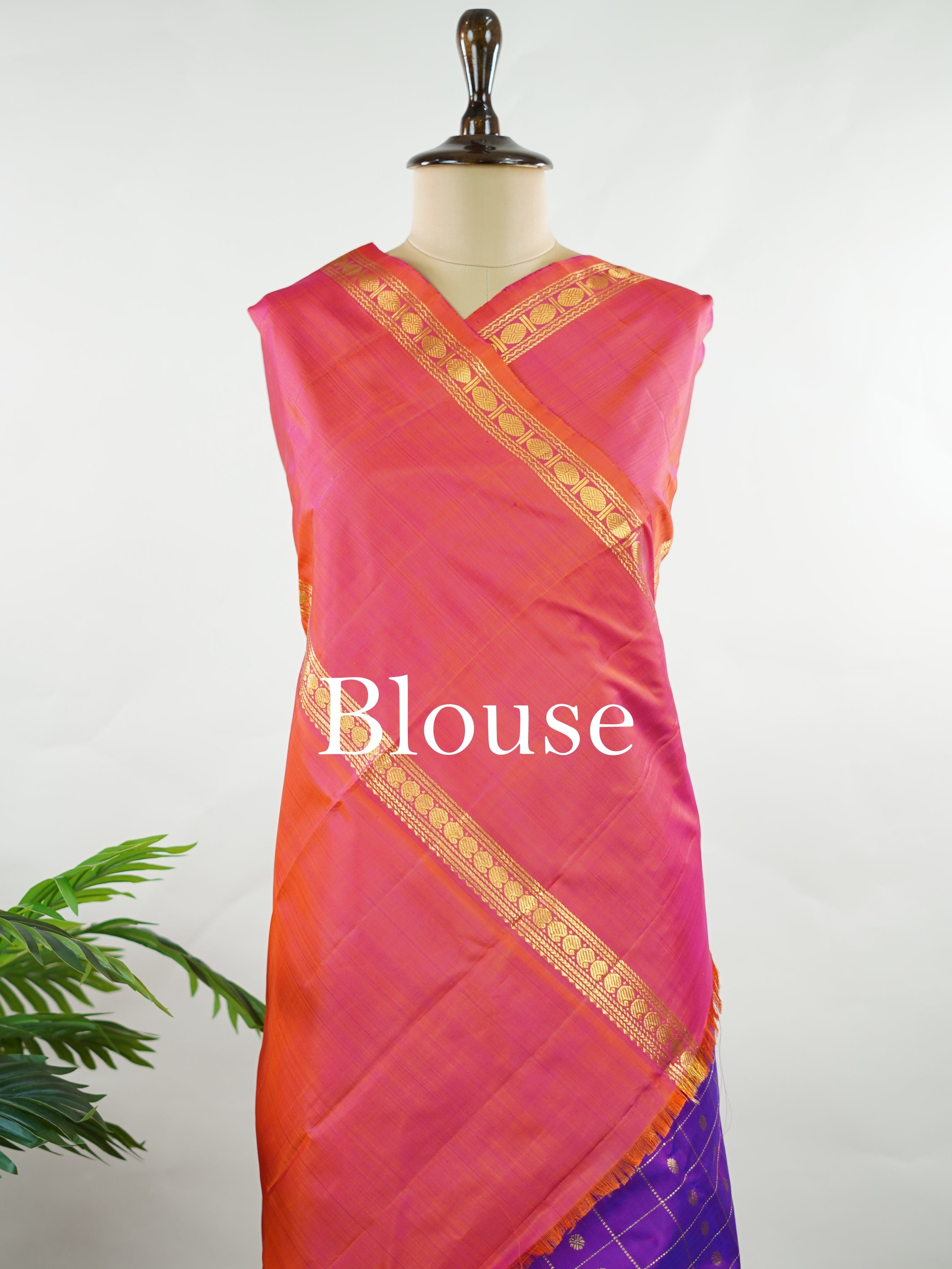 Kanchipuram Silk Elegant and striking, this violet Kanjivaram saree is woven in luxurious 100% pure silk for a rich, graceful drape. The body is adorned with delicate buttis, while the contrasting pinkish orange gap border adds a bold and contemporary touch. A perfect fusion of classic tradition and statement design—ideal for weddings and festive celebrations Mahamaya - Violet Pure Kanjivaram Silk Saree - Manoranjitham Weaves - Handloom Store