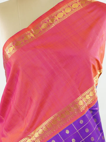 Kanchipuram Silk Elegant and striking, this violet Kanjivaram saree is woven in luxurious 100% pure silk for a rich, graceful drape. The body is adorned with delicate buttis, while the contrasting pinkish orange gap border adds a bold and contemporary touch. A perfect fusion of classic tradition and statement design—ideal for weddings and festive celebrations Mahamaya - Violet Pure Kanjivaram Silk Saree - Manoranjitham Weaves - Handloom Store
