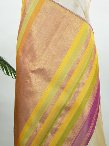 Kanchipuram Silk Soft, elegant, and timeless, this cream Kanjivaram saree is crafted in luxurious 100% pure silk for a graceful drape. The vibrant 8-kol multi-colour detailing adds festive richness, while delicate Malli Mogga buttis enhance the body with subtle floral charm. A perfect harmony of tradition and colour—ideal for weddings and special celebrations. Srishti - Manoranjitham Weaves - Handloom Store