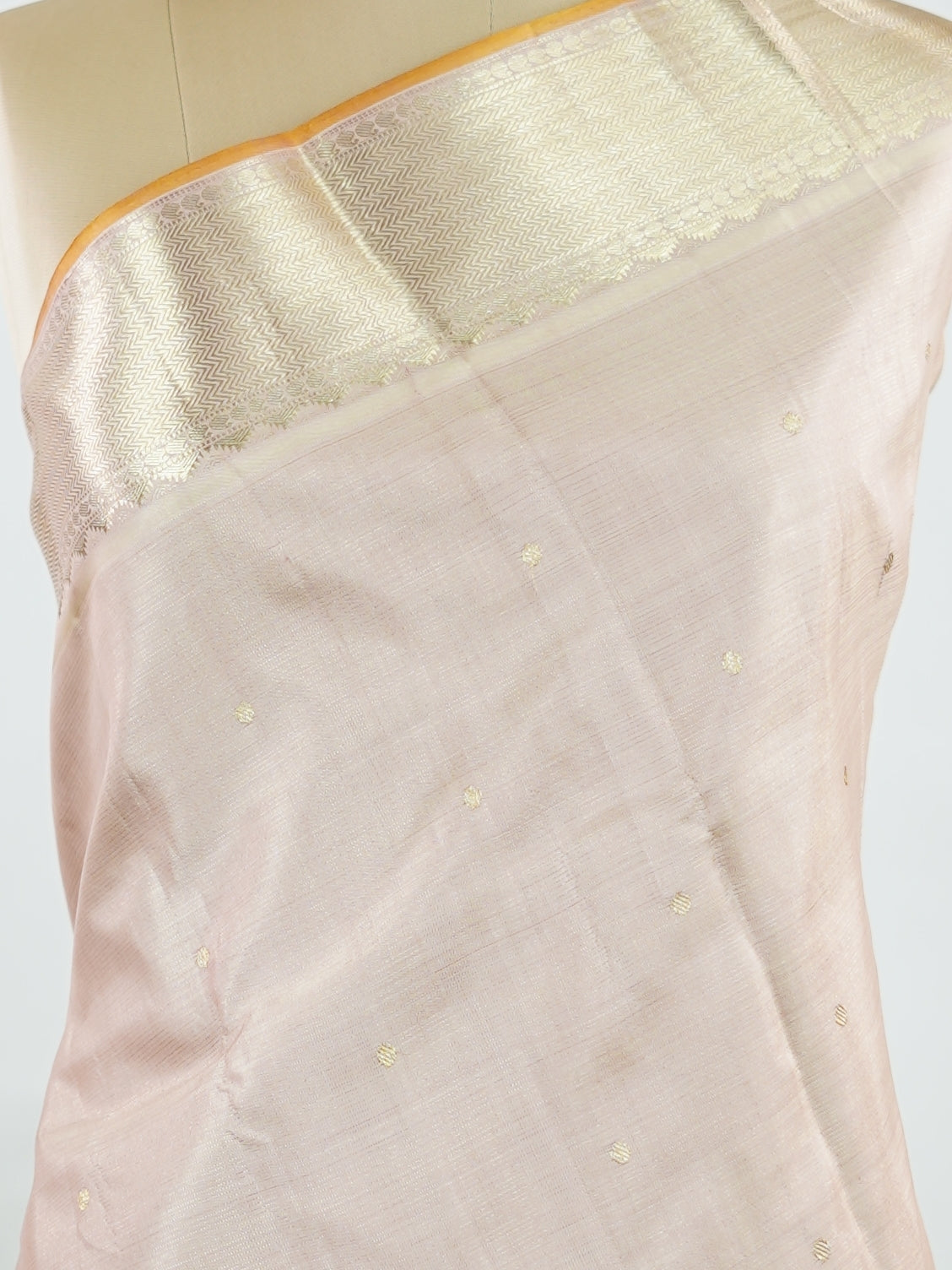 Kanchipuram Silk Understated and elegant, this cream Kanjivaram saree is woven in luxurious 100% pure silk for a soft, graceful drape. Featuring classic Vairavoosi weaving complemented by delicate buttis across the body, it reflects timeless craftsmanship with subtle richness. A refined choice for weddings, traditional gatherings, and serene festive moments. Anandalahari - Cream Pure Kanjivaram Silk Saree - Manoranjitham Weaves - Handloom Store