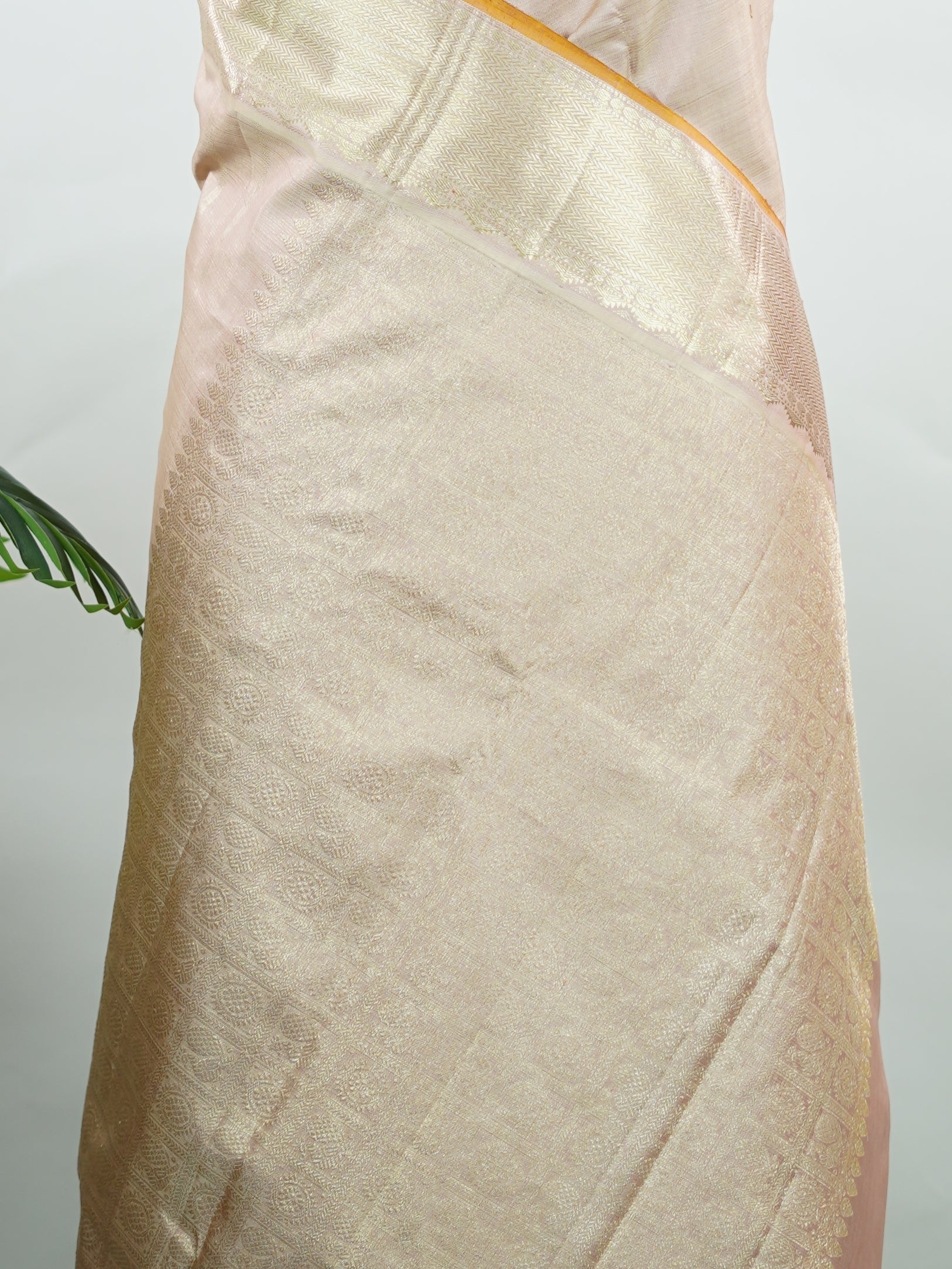 Kanchipuram Silk Understated and elegant, this cream Kanjivaram saree is woven in luxurious 100% pure silk for a soft, graceful drape. Featuring classic Vairavoosi weaving complemented by delicate buttis across the body, it reflects timeless craftsmanship with subtle richness. A refined choice for weddings, traditional gatherings, and serene festive moments. Anandalahari - Cream Pure Kanjivaram Silk Saree - Manoranjitham Weaves - Handloom Store