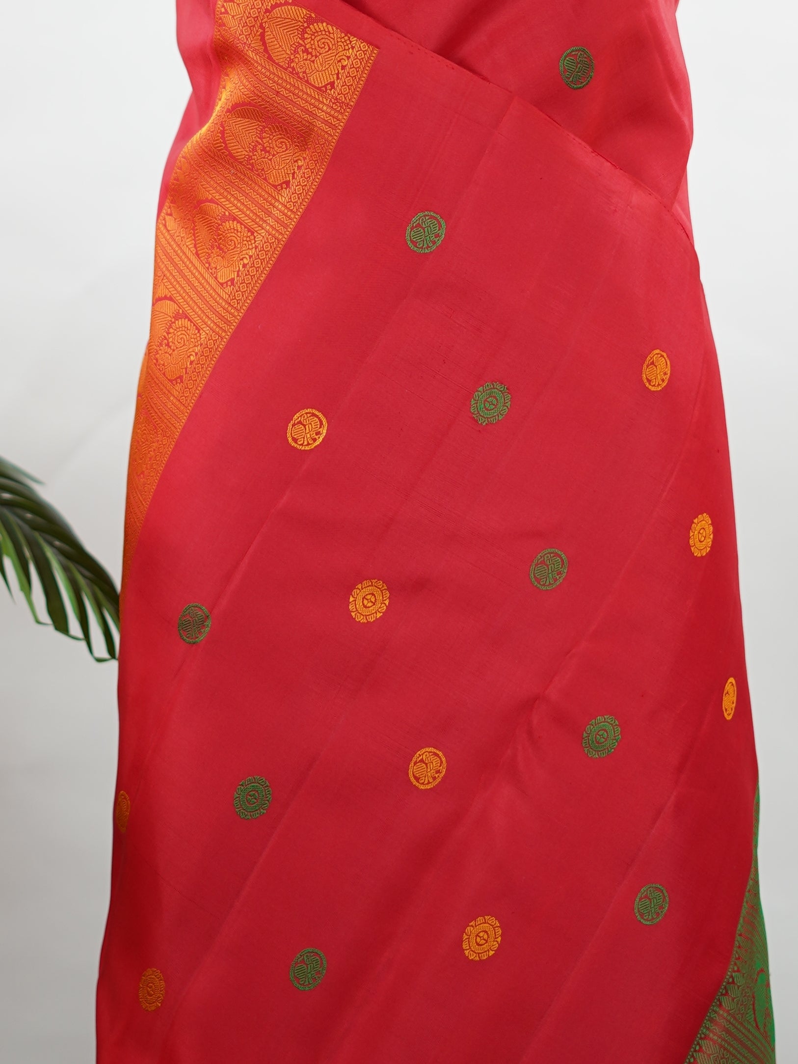 Kanchipuram Silk Bold and timeless, this red Kanjivaram saree is crafted in luxurious 100% pure silk for a rich, structured drape. Designed without zari, it features elegant resham buttas woven all over the body, creating refined texture with subtle sophistication. A perfect blend of tradition and minimal elegance—ideal for weddings, festive occasions, and classic celebrations. Devipriya - Red Pure Kanjivaram Silk Saree - Manoranjitham Weaves - Handloom Store