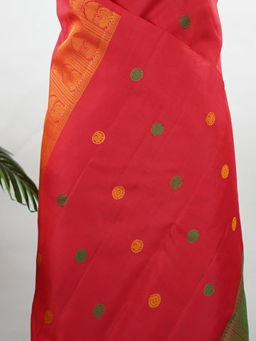 Kanchipuram Silk Bold and timeless, this red Kanjivaram saree is crafted in luxurious 100% pure silk for a rich, structured drape. Designed without zari, it features elegant resham buttas woven all over the body, creating refined texture with subtle sophistication. A perfect blend of tradition and minimal elegance—ideal for weddings, festive occasions, and classic celebrations. Devipriya - Red Pure Kanjivaram Silk Saree - Manoranjitham Weaves - Handloom Store