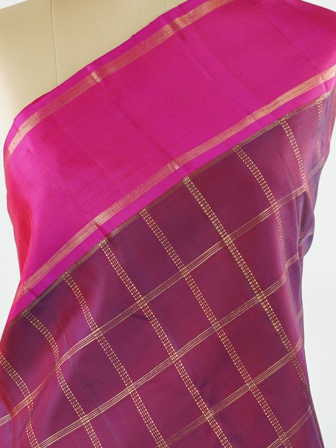 Kanchipuram Silk Rich and regal, this maroon Kanjivaram saree is crafted in luxurious 100% pure silk. The bold big checks create a striking traditional pattern, beautifully complemented by a contrasting pink gatti border. A grand and timeless choice for weddings and festive occasions. Shivaduti - Maroon Pure Kanjivaram Silk Saree | Classic Checks - Manoranjitham Weaves - Handloom Store
