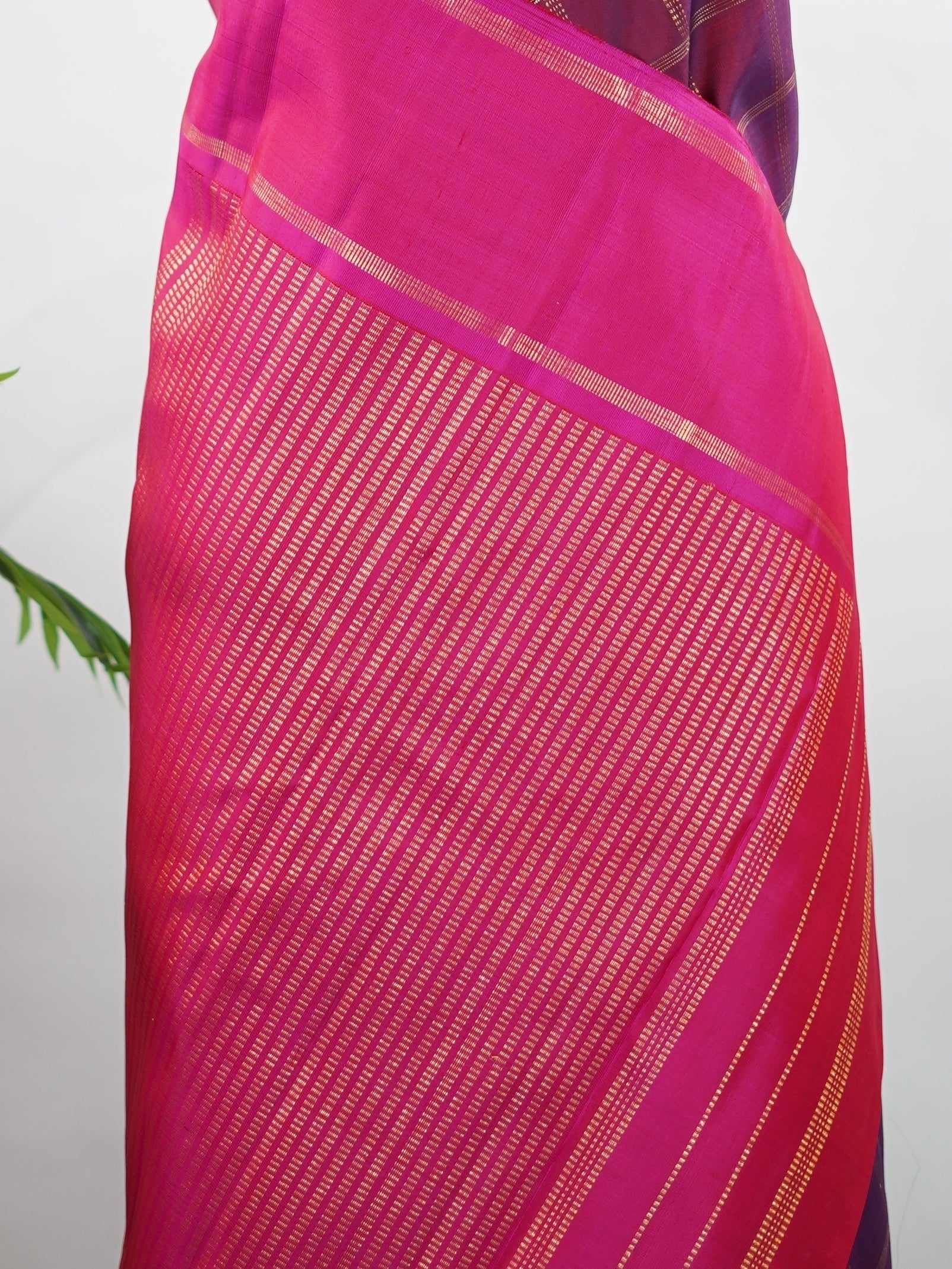 Kanchipuram Silk Rich and regal, this maroon Kanjivaram saree is crafted in luxurious 100% pure silk. The bold big checks create a striking traditional pattern, beautifully complemented by a contrasting pink gatti border. A grand and timeless choice for weddings and festive occasions. Shivaduti - Maroon Pure Kanjivaram Silk Saree | Classic Checks - Manoranjitham Weaves - Handloom Store