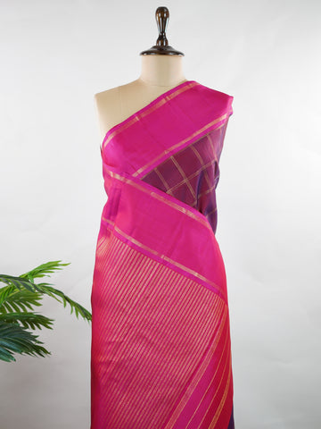 Kanchipuram Silk Rich and regal, this maroon Kanjivaram saree is crafted in luxurious 100% pure silk. The bold big checks create a striking traditional pattern, beautifully complemented by a contrasting pink gatti border. A grand and timeless choice for weddings and festive occasions. Shivaduti - Maroon Pure Kanjivaram Silk Saree | Classic Checks - Manoranjitham Weaves - Handloom Store