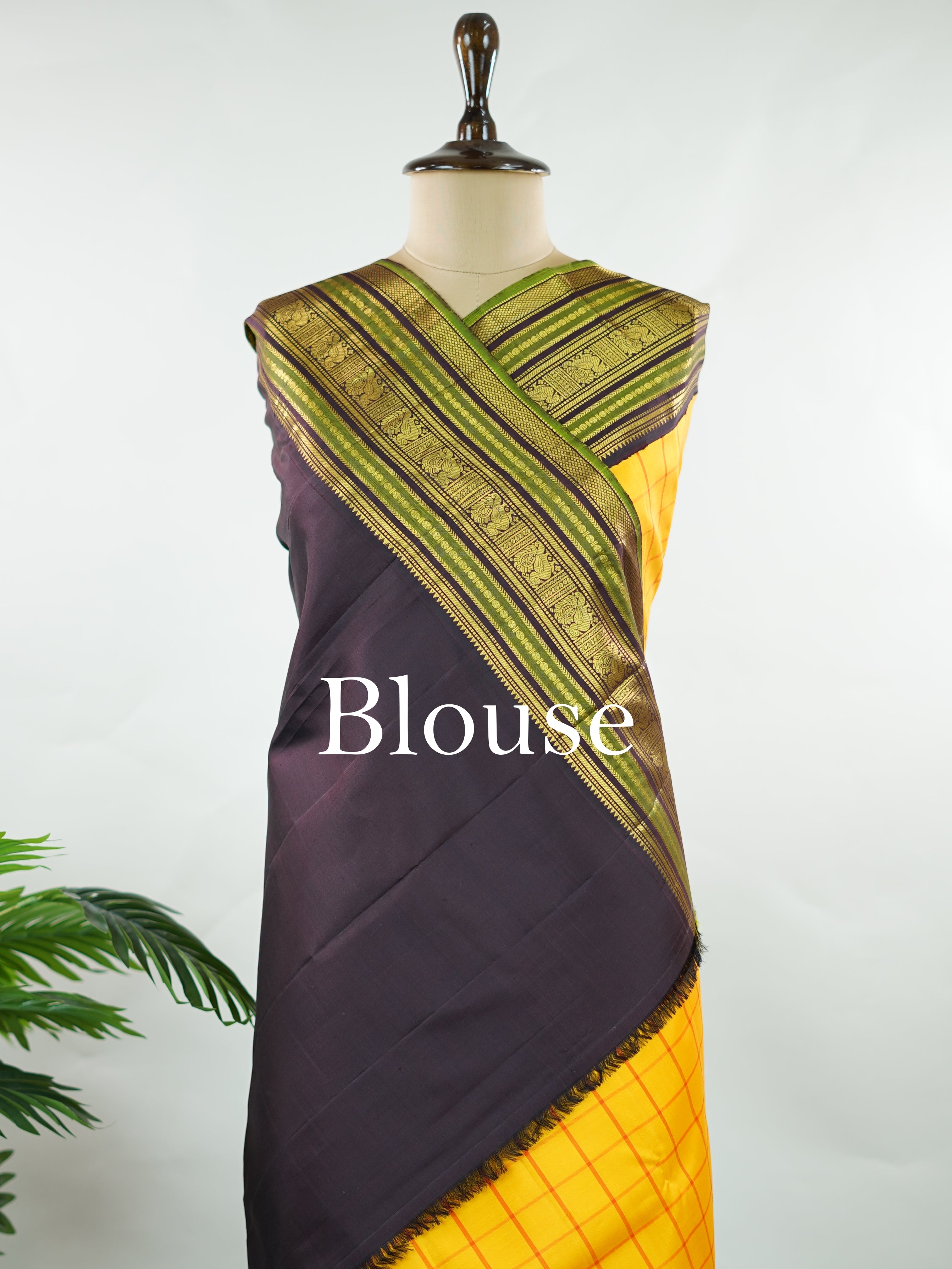Kanchipuram Silk Bright and earthy in contrast, this yellow Kanjivaram saree features classic checks that enhance its traditional charm. The snuff-toned gatti border adds depth and definition, making it a vibrant yet elegant pick for celebrations and special gatherings Nityakalyani - Manoranjitham Weaves - Handloom Store