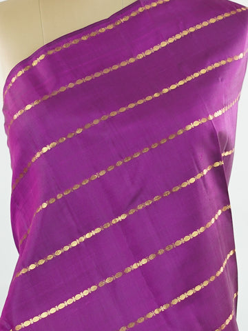 Kanchipuram Silk Bold and contemporary, this magenta pink Kanjivaram saree is woven in rich pure silk with classic Veldhari detailing. Designed without a border, it offers a seamless, modern aesthetic while retaining timeless heritage appeal. A perfect statement piece for festive elegance. Sarvamangala - Pink Pure Kanjivaram Silk Saree | Veldhari Weave - Manoranjitham Weaves - Handloom Store