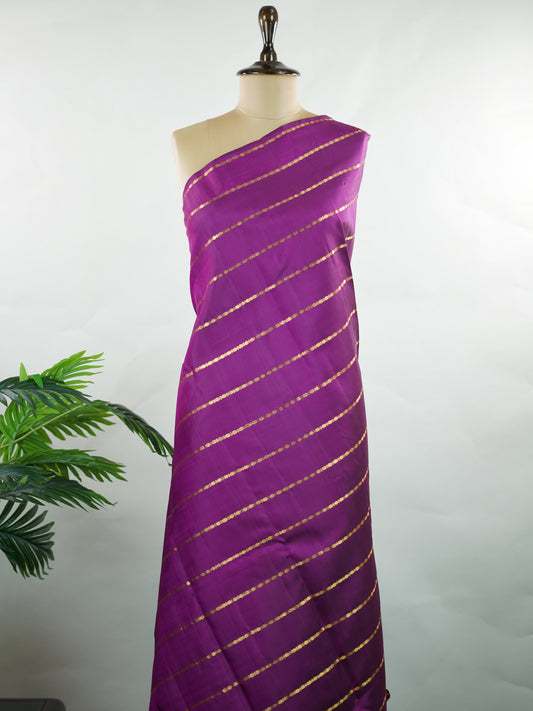 Kanchipuram Silk Bold and contemporary, this magenta pink Kanjivaram saree is woven in rich pure silk with classic Veldhari detailing. Designed without a border, it offers a seamless, modern aesthetic while retaining timeless heritage appeal. A perfect statement piece for festive elegance. Sarvamangala - Manoranjitham Weaves - Handloom Store