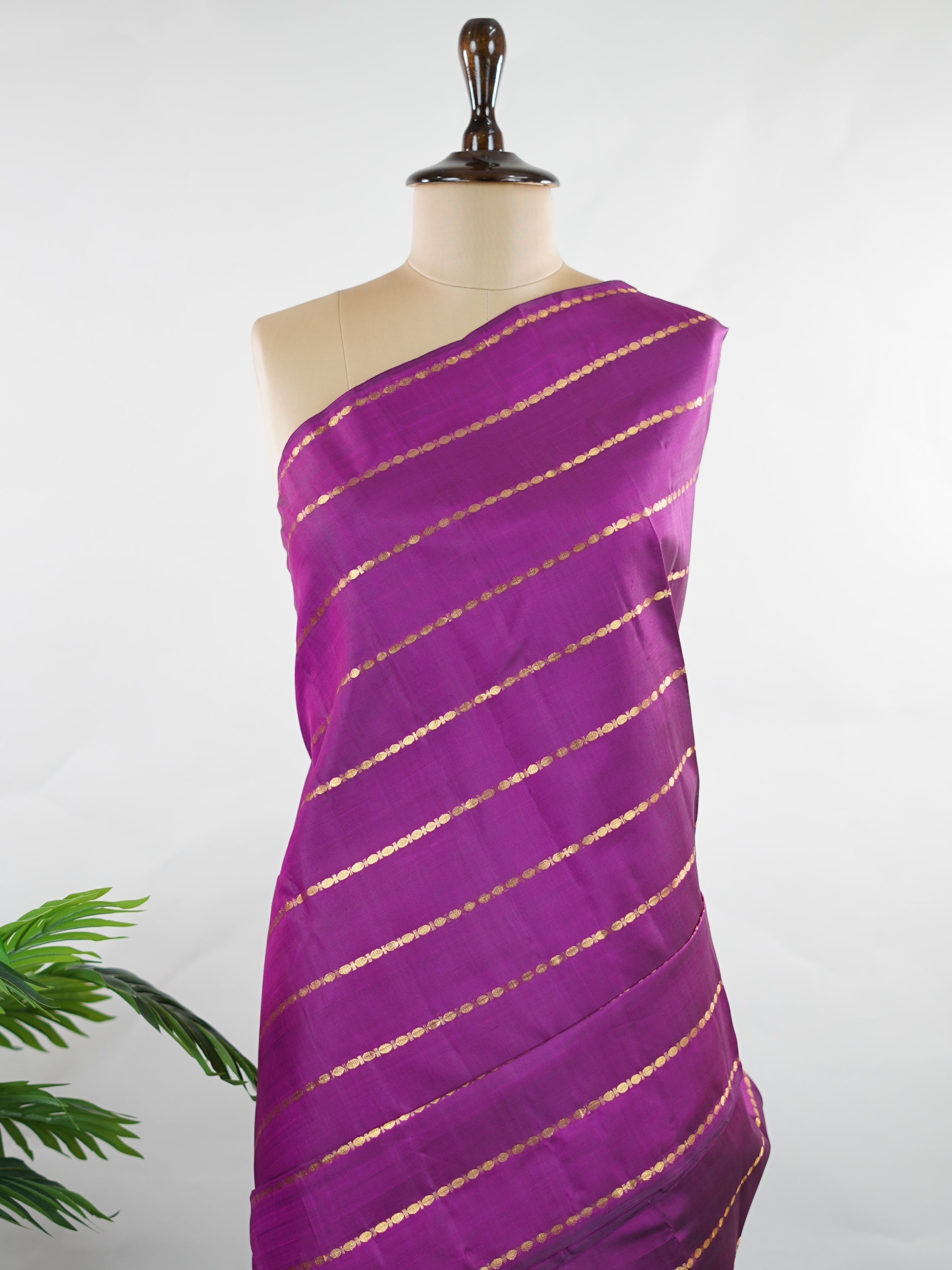 Kanchipuram Silk Bold and contemporary, this magenta pink Kanjivaram saree is woven in rich pure silk with classic Veldhari detailing. Designed without a border, it offers a seamless, modern aesthetic while retaining timeless heritage appeal. A perfect statement piece for festive elegance. Sarvamangala - Pink Pure Kanjivaram Silk Saree | Veldhari Weave - Manoranjitham Weaves - Handloom Store