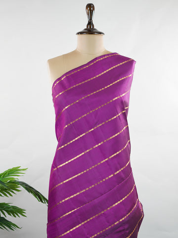 Kanchipuram Silk Bold and contemporary, this magenta pink Kanjivaram saree is woven in rich pure silk with classic Veldhari detailing. Designed without a border, it offers a seamless, modern aesthetic while retaining timeless heritage appeal. A perfect statement piece for festive elegance. Sarvamangala - Pink Pure Kanjivaram Silk Saree | Veldhari Weave - Manoranjitham Weaves - Handloom Store