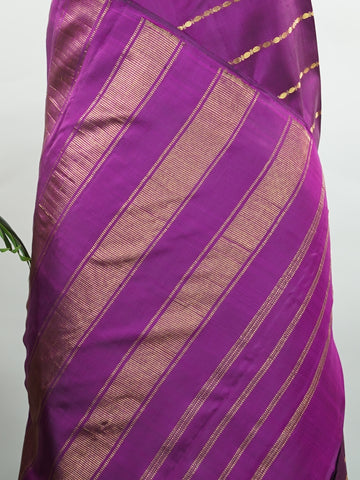 Kanchipuram Silk Bold and contemporary, this magenta pink Kanjivaram saree is woven in rich pure silk with classic Veldhari detailing. Designed without a border, it offers a seamless, modern aesthetic while retaining timeless heritage appeal. A perfect statement piece for festive elegance. Sarvamangala - Pink Pure Kanjivaram Silk Saree | Veldhari Weave - Manoranjitham Weaves - Handloom Store