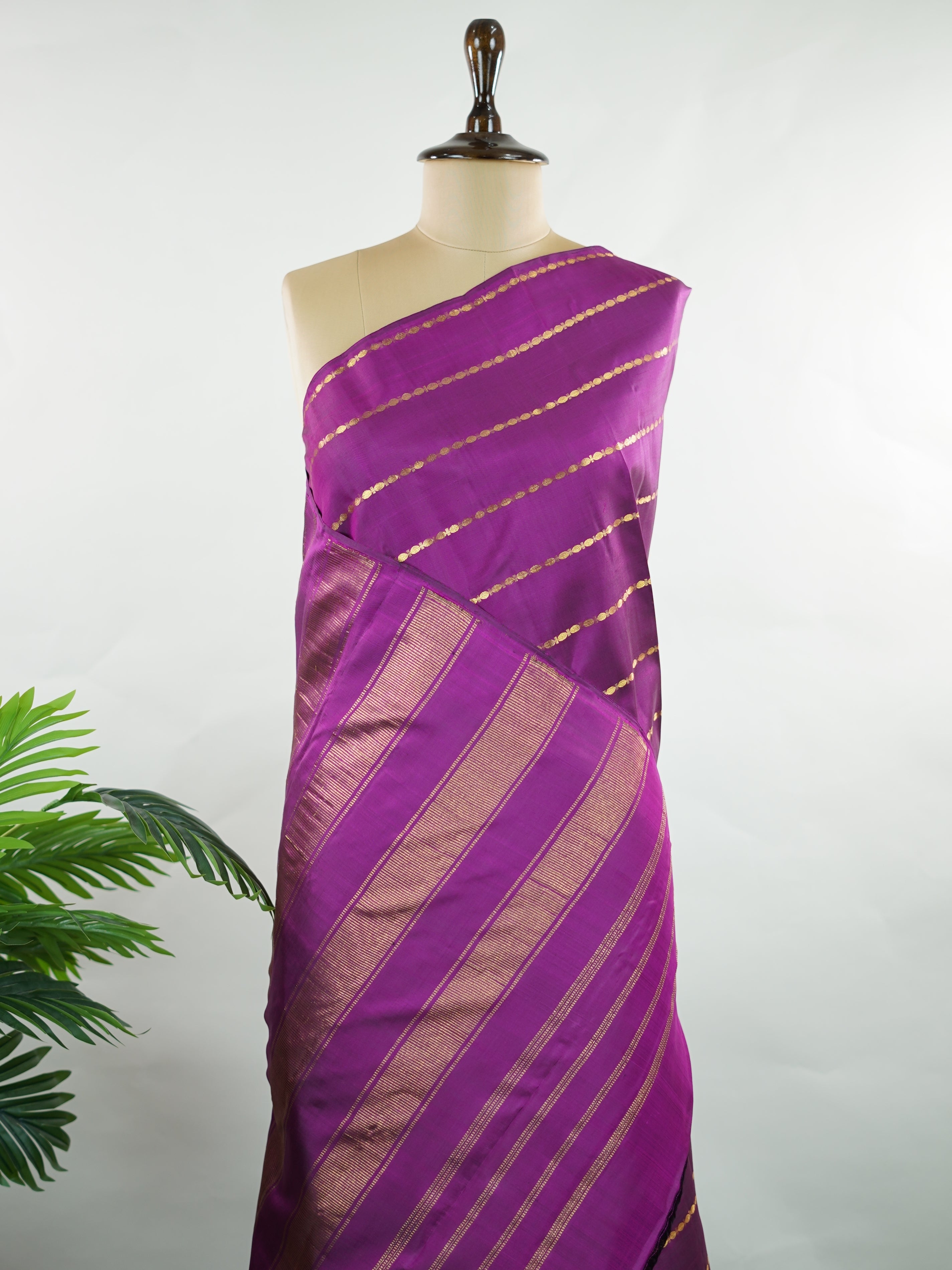 Kanchipuram Silk Bold and contemporary, this magenta pink Kanjivaram saree is woven in rich pure silk with classic Veldhari detailing. Designed without a border, it offers a seamless, modern aesthetic while retaining timeless heritage appeal. A perfect statement piece for festive elegance. Sarvamangala - Manoranjitham Weaves - Handloom Store