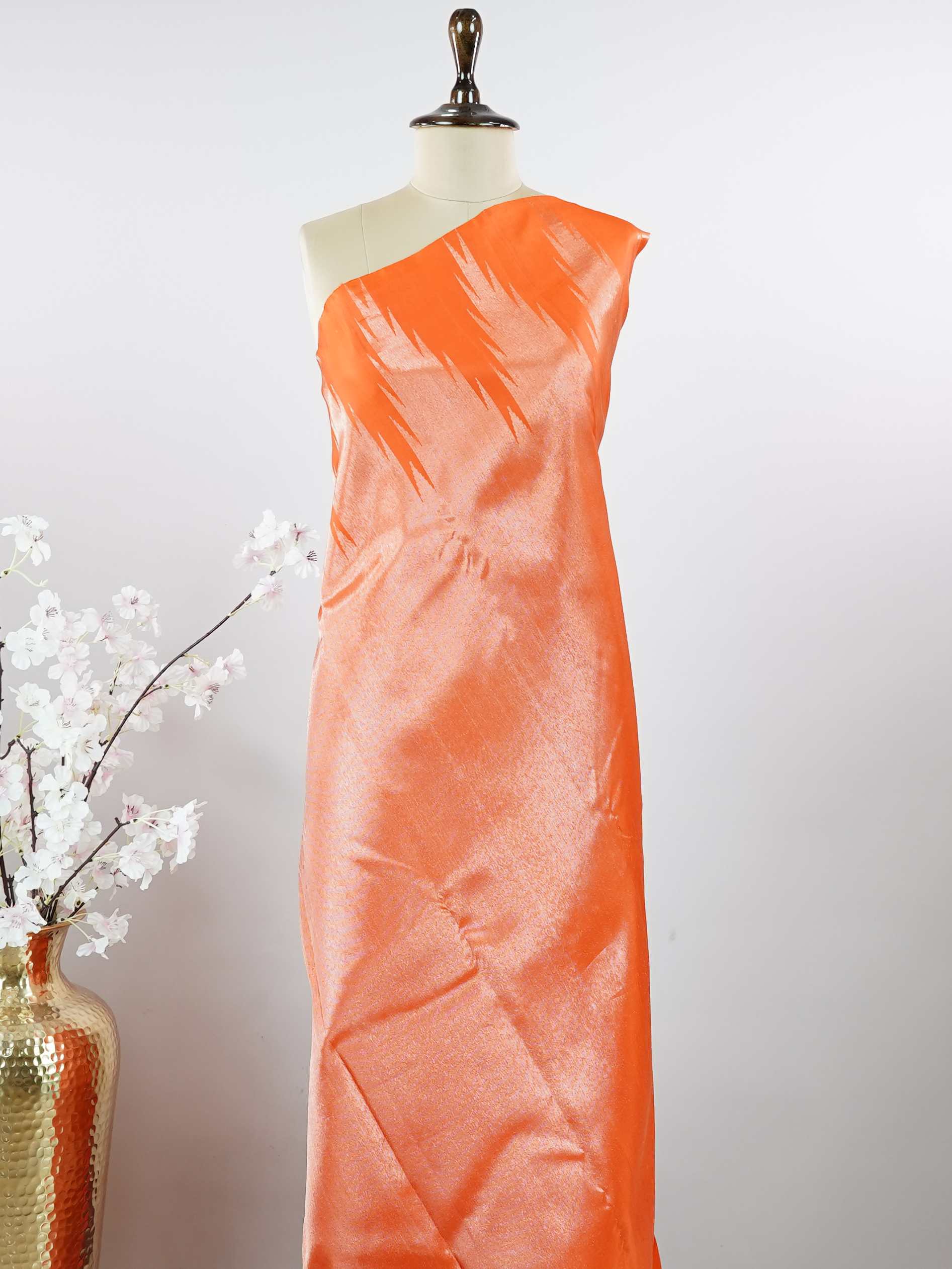 Kanchipuram Silk Striking and festive, this orange Kanjivaram saree is enhanced with rich purple contrast and detailed 8-kol borders. The luxurious silk drape and vibrant colour pairing make it an ideal choice for weddings and grand celebrations. Keertana - Orange Pure Kanjivaram Silk Saree - Manoranjitham Weaves - Handloom Store