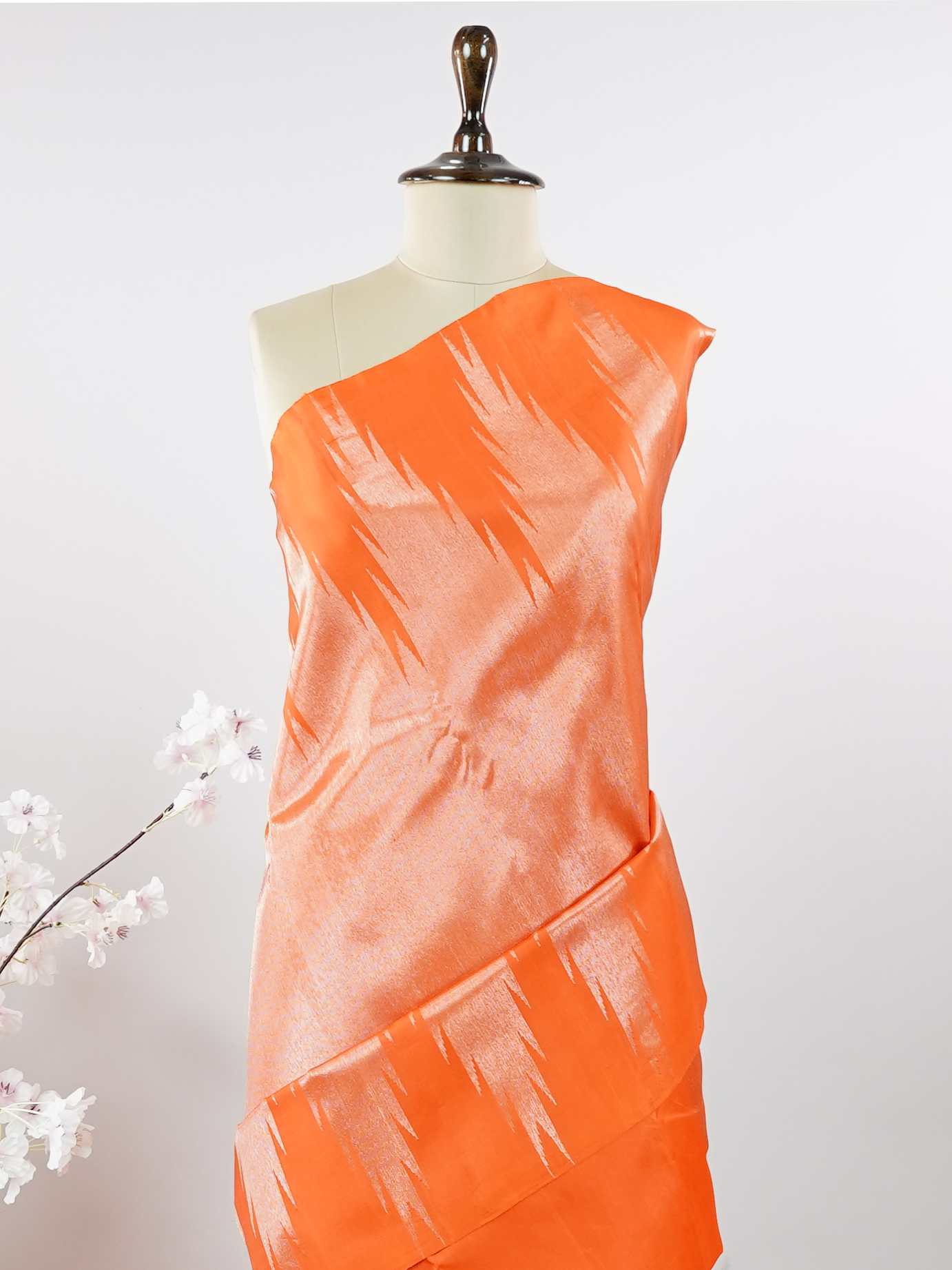 Kanchipuram Silk Striking and festive, this orange Kanjivaram saree is enhanced with rich purple contrast and detailed 8-kol borders. The luxurious silk drape and vibrant colour pairing make it an ideal choice for weddings and grand celebrations. Keertana - Orange Pure Kanjivaram Silk Saree - Manoranjitham Weaves - Handloom Store
