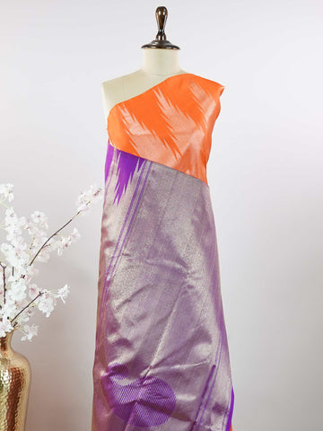 Kanchipuram Silk Striking and festive, this orange Kanjivaram saree is enhanced with rich purple contrast and detailed 8-kol borders. The luxurious silk drape and vibrant colour pairing make it an ideal choice for weddings and grand celebrations. Keertana - Orange Pure Kanjivaram Silk Saree - Manoranjitham Weaves - Handloom Store