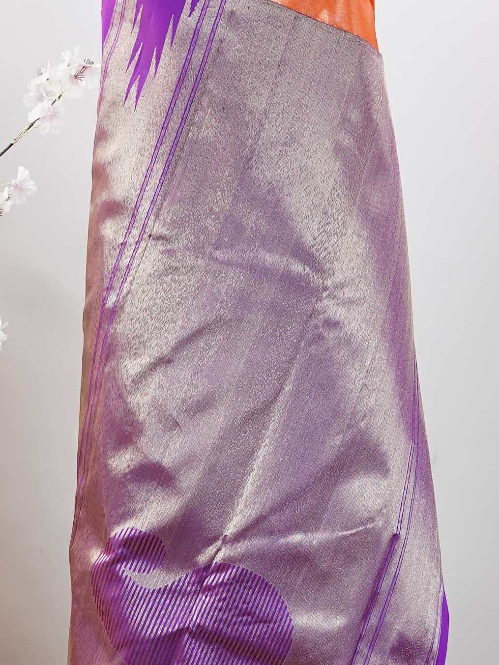 Kanchipuram Silk Striking and festive, this orange Kanjivaram saree is enhanced with rich purple contrast and detailed 8-kol borders. The luxurious silk drape and vibrant colour pairing make it an ideal choice for weddings and grand celebrations. Keertana - Orange Pure Kanjivaram Silk Saree - Manoranjitham Weaves - Handloom Store