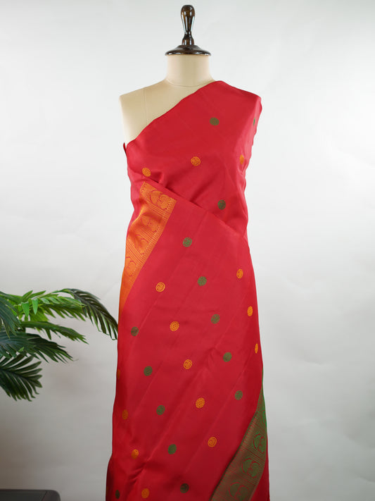 Kanchipuram Silk Bold and timeless, this red Kanjivaram saree is crafted in luxurious 100% pure silk for a rich, structured drape. Designed without zari, it features elegant resham buttas woven all over the body, creating refined texture with subtle sophistication. A perfect blend of tradition and minimal elegance—ideal for weddings, festive occasions, and classic celebrations. Devipriya - Manoranjitham Weaves - Handloom Store