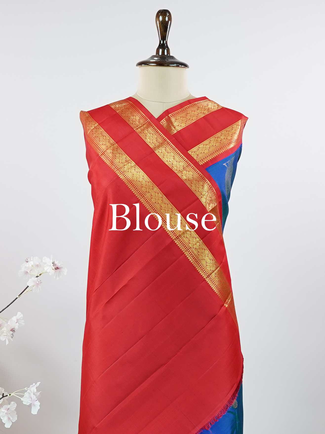 Kanchipuram Silk This exquisite Kanjivaram saree features a blue body with a striking red border, crafted from 100% pure silk.br
The body showcases a Korvai/Kuttu pattern, adorned with delicate flower motifs and peacocks flanking the border.br
Finished with elegant detailing, it beautifully highlights traditional handloom craftsmanship and timeless Kanchipuram artistry. Shivashakti - Blue Pure Kanjivaram Silk Saree - Manoranjitham Weaves - Handloom Store