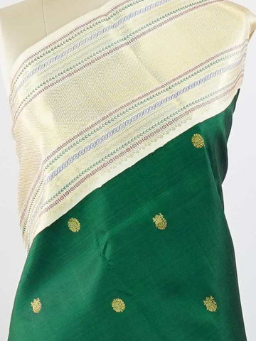 Kanchipuram Silk This beautiful Kanjivaram saree features a green body paired with a cream border, crafted from 100% pure silk.br
The body is adorned with intricate Irutali Pakshi (two-headed Ganda Beruda) motifs, showcasing traditional handloom artistry.br
Finished with elegant cream borders, it exudes timeless charm and classic Kanchipuram craftsmanship. Padmaragini - Green Pure Kanjivaram Silk Saree - Manoranjitham Weaves - Handloom Store