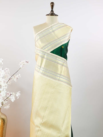 Kanchipuram Silk This beautiful Kanjivaram saree features a green body paired with a cream border, crafted from 100% pure silk.br
The body is adorned with intricate Irutali Pakshi (two-headed Ganda Beruda) motifs, showcasing traditional handloom artistry.br
Finished with elegant cream borders, it exudes timeless charm and classic Kanchipuram craftsmanship. Padmaragini - Green Pure Kanjivaram Silk Saree - Manoranjitham Weaves - Handloom Store