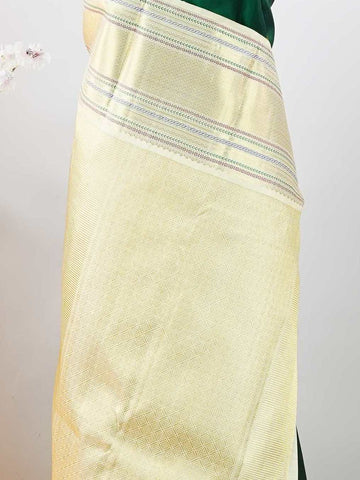 Kanchipuram Silk This beautiful Kanjivaram saree features a green body paired with a cream border, crafted from 100% pure silk.br
The body is adorned with intricate Irutali Pakshi (two-headed Ganda Beruda) motifs, showcasing traditional handloom artistry.br
Finished with elegant cream borders, it exudes timeless charm and classic Kanchipuram craftsmanship. Padmaragini - Green Pure Kanjivaram Silk Saree - Manoranjitham Weaves - Handloom Store