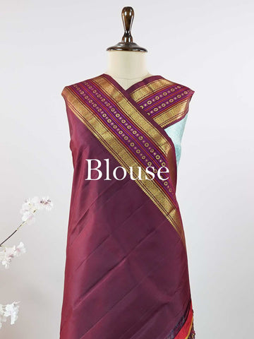 Kanchipuram Silk This elegant Kanjivaram saree features an aqua blue body with a rich maroon border, crafted from 100% pure silk. Handloom woven with full brocade and intricate meena work on the border and pallu, it reflects the timeless artistry of Kanchipuram. Chintamani - Aqua Blue Pure Kanjivaram Silk Saree - Manoranjitham Weaves - Handloom Store