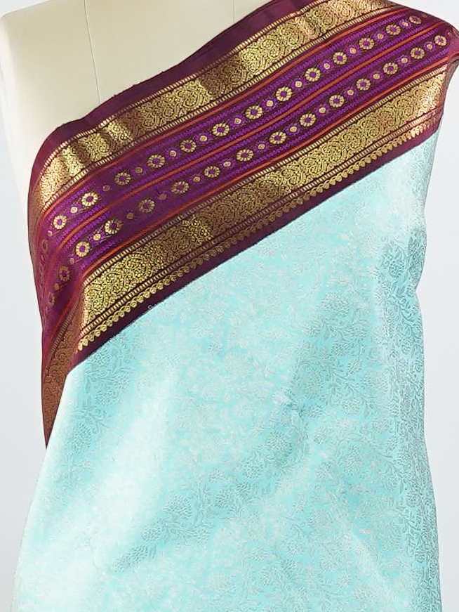 Kanchipuram Silk This elegant Kanjivaram saree features an aqua blue body with a rich maroon border, crafted from 100% pure silk. Handloom woven with full brocade and intricate meena work on the border and pallu, it reflects the timeless artistry of Kanchipuram. Chintamani - Aqua Blue Pure Kanjivaram Silk Saree - Manoranjitham Weaves - Handloom Store