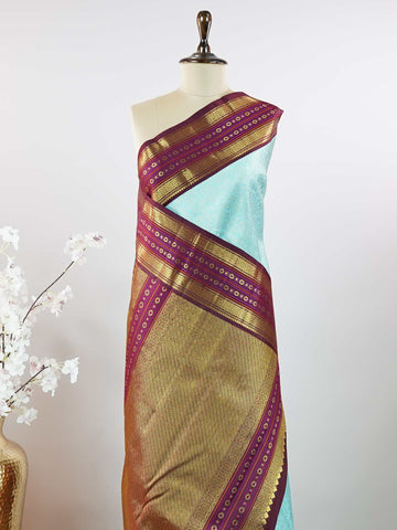 Kanchipuram Silk This elegant Kanjivaram saree features an aqua blue body with a rich maroon border, crafted from 100% pure silk. Handloom woven with full brocade and intricate meena work on the border and pallu, it reflects the timeless artistry of Kanchipuram. Chintamani - Aqua Blue Pure Kanjivaram Silk Saree - Manoranjitham Weaves - Handloom Store