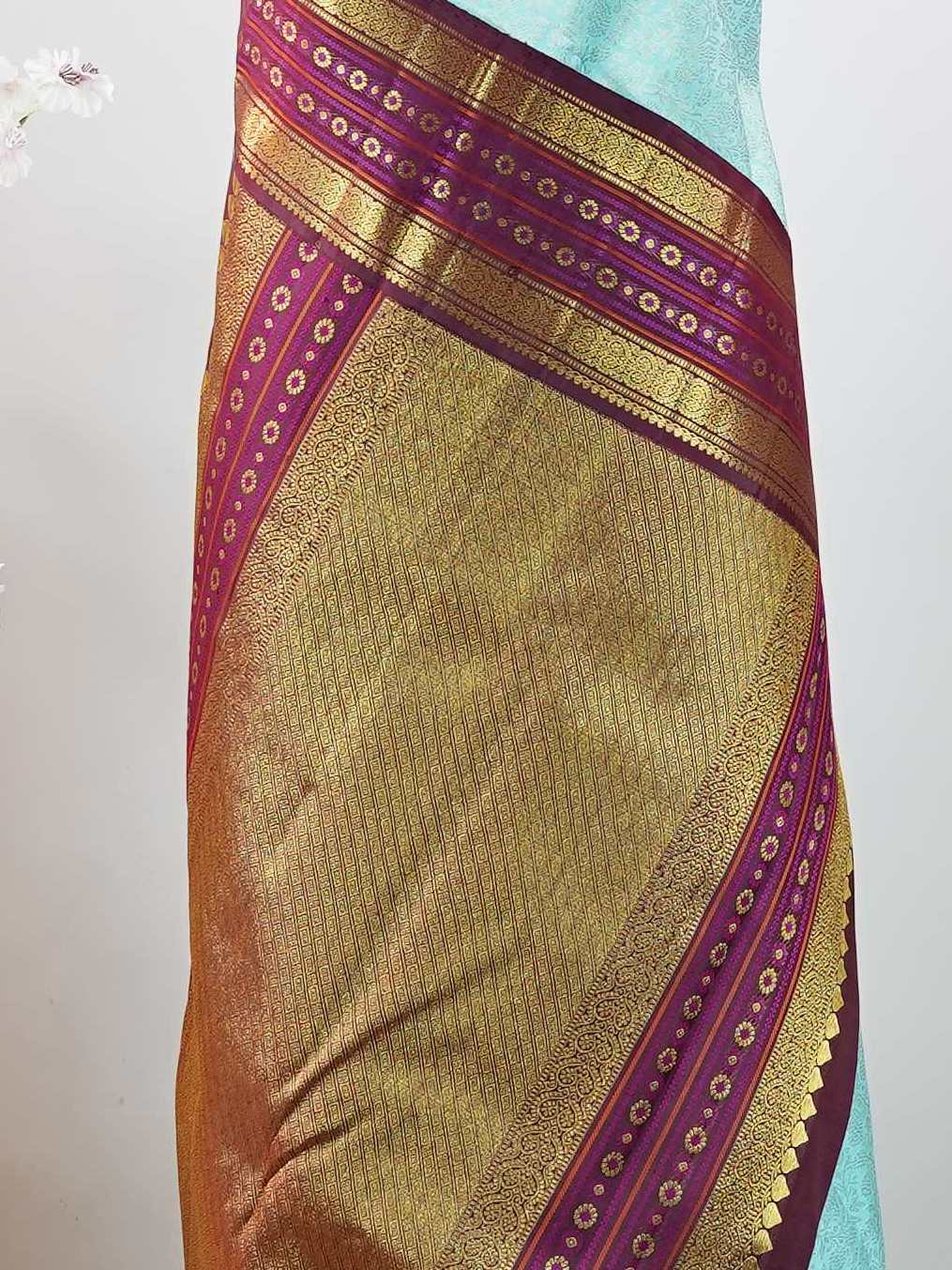 Kanchipuram Silk This elegant Kanjivaram saree features an aqua blue body with a rich maroon border, crafted from 100% pure silk. Handloom woven with full brocade and intricate meena work on the border and pallu, it reflects the timeless artistry of Kanchipuram. Chintamani - Aqua Blue Pure Kanjivaram Silk Saree - Manoranjitham Weaves - Handloom Store