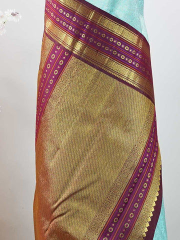 Kanchipuram Silk This elegant Kanjivaram saree features an aqua blue body with a rich maroon border, crafted from 100% pure silk. Handloom woven with full brocade and intricate meena work on the border and pallu, it reflects the timeless artistry of Kanchipuram. Chintamani - Aqua Blue Pure Kanjivaram Silk Saree - Manoranjitham Weaves - Handloom Store