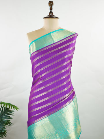 Kanchipuram Silk This Kanjivaram silk saree, adorned in Violet and detailed with Pure Zari weaving, reflects the grandeur of Kanchipuram. The timeless Buttis motifs enhance its bridal charm. A perfect blend of luxury and tradition, it is designed for those who appreciate fine craftsmanship. Sarasangi - Manoranjitham Weaves - Handloom Store