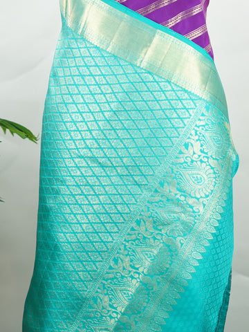 Kanchipuram Silk This Kanjivaram silk saree, adorned in Violet and detailed with Pure Zari weaving, reflects the grandeur of Kanchipuram. The timeless Buttis motifs enhance its bridal charm. A perfect blend of luxury and tradition, it is designed for those who appreciate fine craftsmanship. Sarasangi - Manoranjitham Weaves - Handloom Store