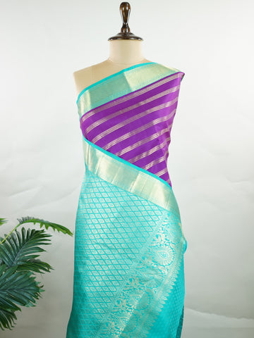 Kanchipuram Silk This Kanjivaram silk saree, adorned in Violet and detailed with Pure Zari weaving, reflects the grandeur of Kanchipuram. The timeless Buttis motifs enhance its bridal charm. A perfect blend of luxury and tradition, it is designed for those who appreciate fine craftsmanship. Sarasangi - Manoranjitham Weaves - Handloom Store