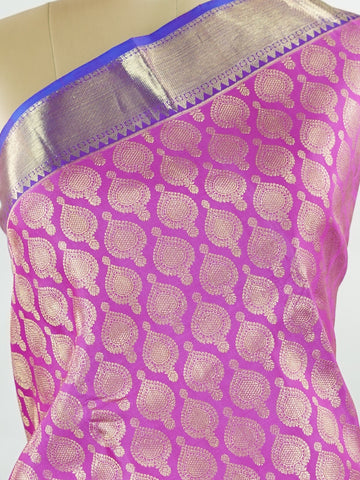 Kanchipuram Silk A masterpiece from Kanchipuram, this Kanjivaram saree in Pink is a tribute to India's rich handloom legacy. The Pure Zari weaving and Buttis motifs make it a perfect choice for brides and celebrations. Every thread speaks of elegance, tradition, and the skilled hands that bring this saree to life. Dwijavanthi - Manoranjitham Weaves - Handloom Store