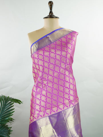 Kanchipuram Silk A masterpiece from Kanchipuram, this Kanjivaram saree in Pink is a tribute to India's rich handloom legacy. The Pure Zari weaving and Buttis motifs make it a perfect choice for brides and celebrations. Every thread speaks of elegance, tradition, and the skilled hands that bring this saree to life. Dwijavanthi - Manoranjitham Weaves - Handloom Store