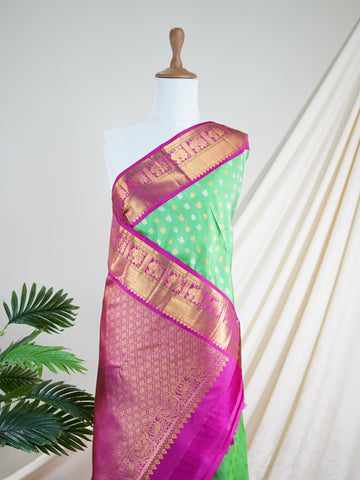 Kanchipuram Silk A masterpiece from Kanchipuram, this Kanjivaram saree in Lime Tree Green is a tribute to India's rich handloom legacy. The Pure Zari weaving and Buttis motifs make it a perfect choice for brides and celebrations. Every thread speaks of elegance, tradition, and the skilled hands that bring this saree to life. Nattakurinji - Manoranjitham Weaves - Handloom Store
