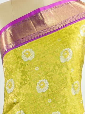 Kanchipuram Silk This Kanjivaram silk saree, adorned in Olive Green and detailed with Pure Zari weaving, reflects the grandeur of Kanchipuram. The timeless Buttis motifs enhance its bridal charm. A perfect blend of luxury and tradition, it is designed for those who appreciate fine craftsmanship. Sahana - Olive Pure Kanjivaram Silk Saree | Pure Zari - Manoranjitham Weaves - Handloom Store