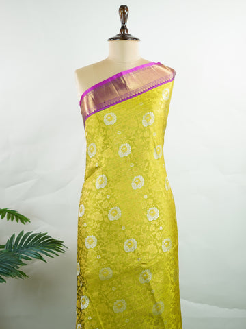Kanchipuram Silk This Kanjivaram silk saree, adorned in Olive Green and detailed with Pure Zari weaving, reflects the grandeur of Kanchipuram. The timeless Buttis motifs enhance its bridal charm. A perfect blend of luxury and tradition, it is designed for those who appreciate fine craftsmanship. Sahana - Olive Pure Kanjivaram Silk Saree | Pure Zari - Manoranjitham Weaves - Handloom Store