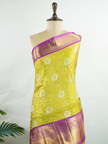 Kanchipuram Silk This Kanjivaram silk saree, adorned in Olive Green and detailed with Pure Zari weaving, reflects the grandeur of Kanchipuram. The timeless Buttis motifs enhance its bridal charm. A perfect blend of luxury and tradition, it is designed for those who appreciate fine craftsmanship. Sahana - Olive Pure Kanjivaram Silk Saree | Pure Zari - Manoranjitham Weaves - Handloom Store