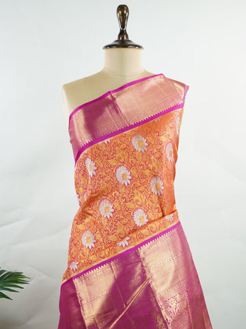 Kanchipuram Silk Handwoven by skilled artisans of Kanchipuram, this Kanjivaram saree in Orange blends traditional elegance with intricate Pure Zari zari work. A truly stunning drape for special occasions. The interplay of colors and craftsmanship makes it a treasured piece for every saree connoisseur. Suratia - Orange Pure Kanjivaram Silk Saree | Pure Zari - Manoranjitham Weaves - Handloom Store